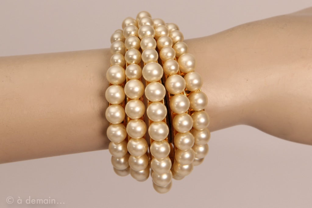 Elegant cuff bracelet by Chanel with white pearls and gold metal. Very elegant and special piece. Curved 2003.