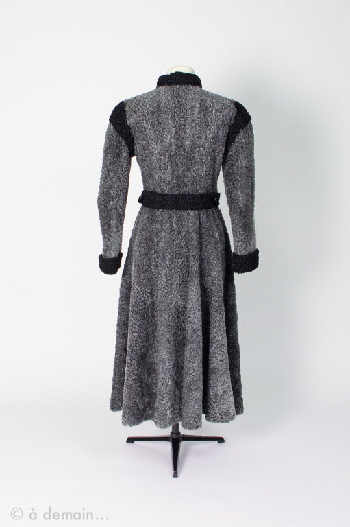 Gorgeous gray and black Astrakhan Coat designed by Christian Dior Boutique  Fourrure, with large frogged buttons of black leather. Russian style from the 1980s, in excellent condition.

FR Size about 36.

dimensions:
Shoulders: 38 cm
Bust: 40