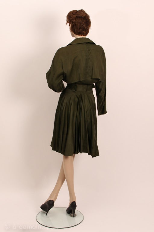 Khaki belted trench-coat with a very special and nice back. Alaïa is the famous french fashion designer, who 