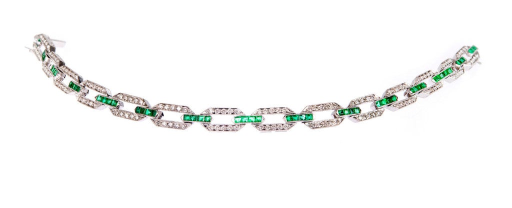 Mint condition original 1930s Art Deco hinged link bracelet in solid Platinum. All stones original and intact. Bright Columbian square Emeralds and fine white diamonds. 

140 round diamonds approx. total weight 1.40cts. 

44 square Emeralds