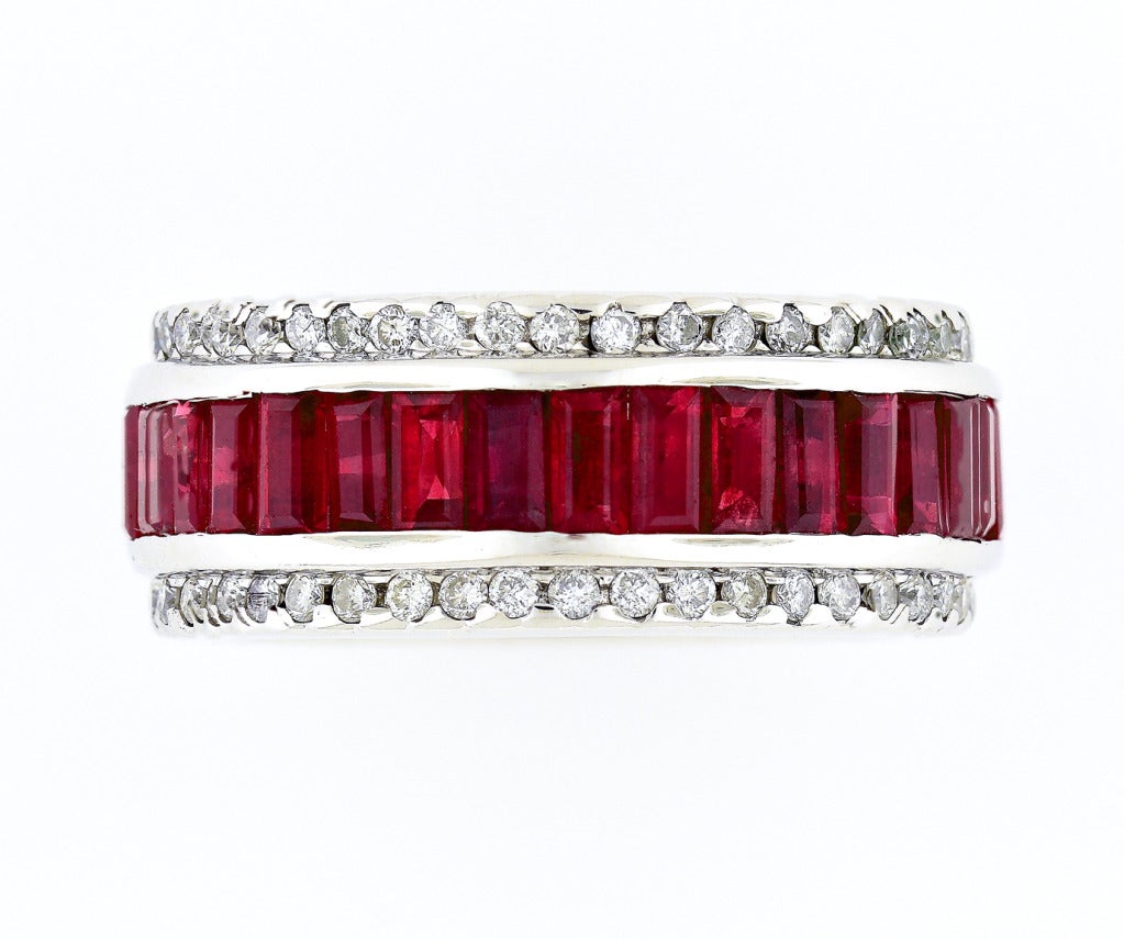 Sonia B 9.1mm wide ruby and diamond,  18k white gold band ring set with 35 bright genuine red Rubies and a row of full cut bright white diamonds top and bottom. 
 
35 emerald cut bright red Rubies 4 x 2mm, approx. total weight 6.50cts 
84 full cut