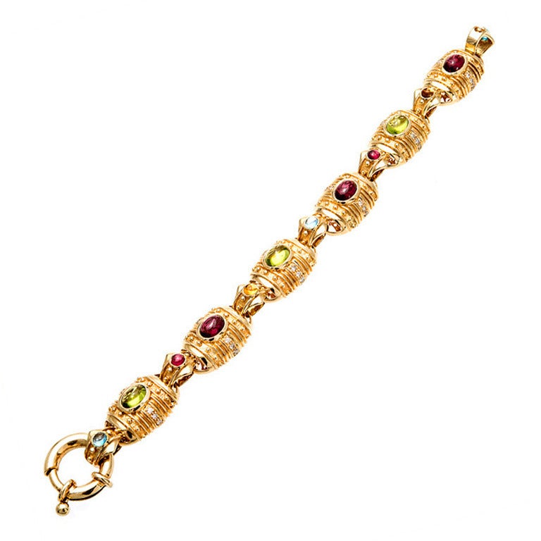 Beautiful Byzantine style 14k yellow gold 6 section bracelet with fine gem Peridot, Garnet, Citrine, Topaz and Diamonds. 

Three 7.5 x 5.5mm fine Peridot cabochons 
Three 7.5 x 5.5mm fine Garnet cabochons 
Two 3.5mm Citrines and Garnets 
Three