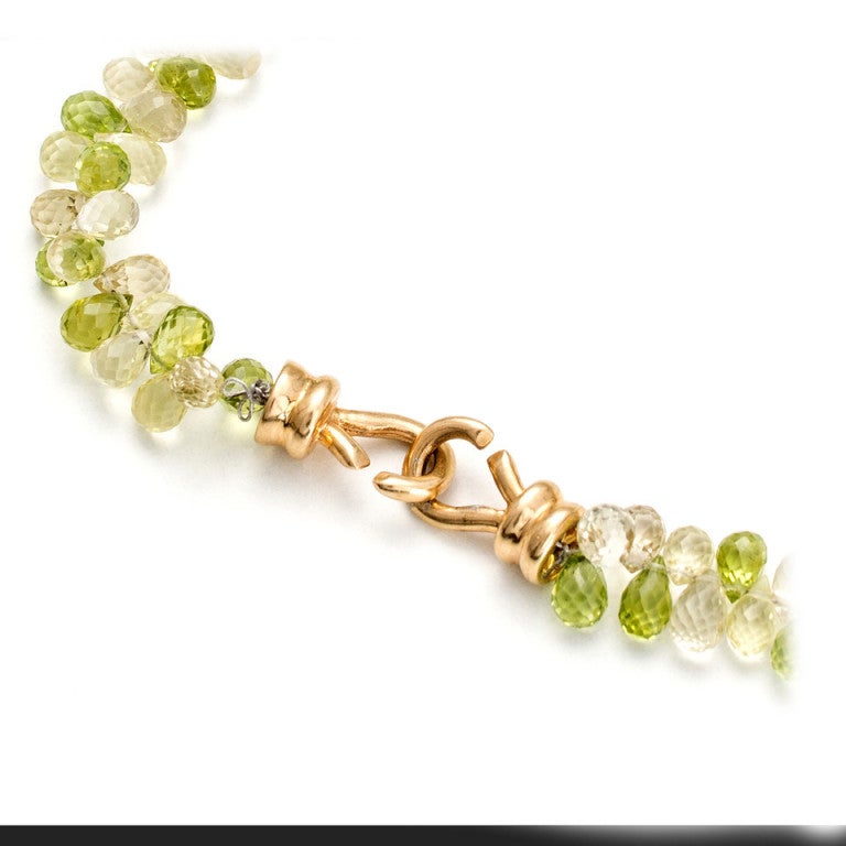 Genuine natural stone graduated Briolette necklace with Peridot and Citrine.    

Approx. 200 Briolette cut Peridot and Citrine natural and untreated, 302.00cts approx. total
Catch tested: 18k yellow gold    
Total width: .4 x .8 inch or 10 x
