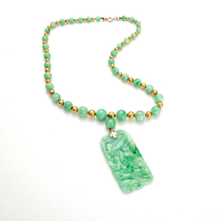 Original Art Deco 1900 to 1920 certified natural Jadeite Jade necklace. Super rare gemstone necklace certified by the AGTA as natural with only type A or surface waxing. Excellent luster and condition. Heavy thick walled 14k beads. Beautiful