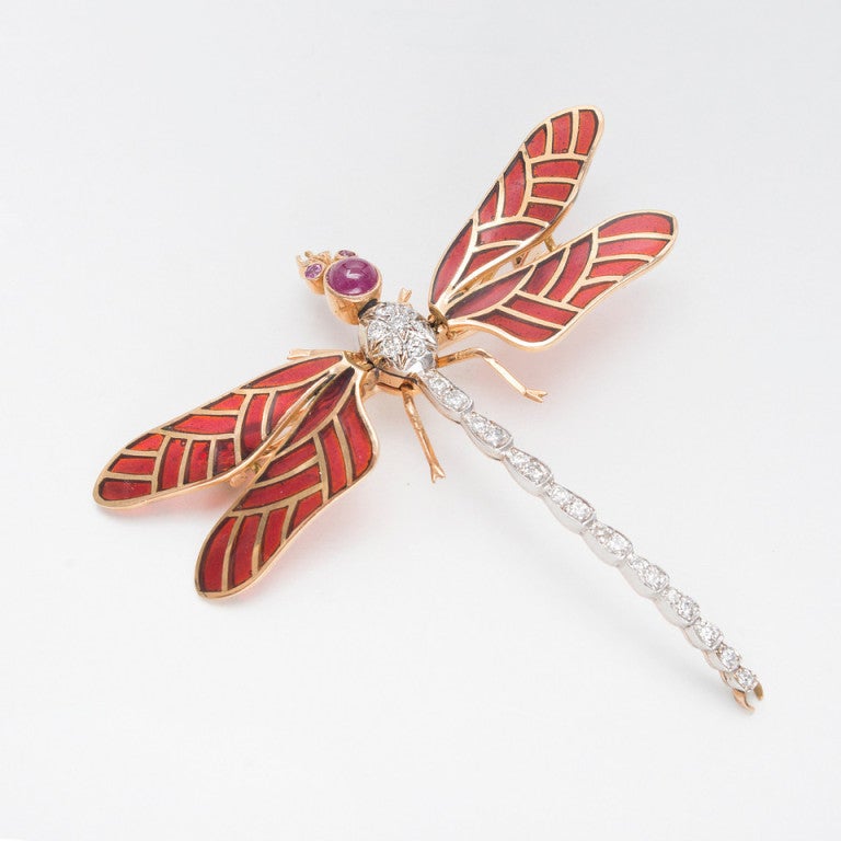Life like large 3-D 18k yellow gold dragonfly pin with a white gold body set with beautiful full cut white diamonds. The eyes and head are genuine Rubies. The wings move up and down Entremblant and have reddish brown plique an hour enamel. Excellent