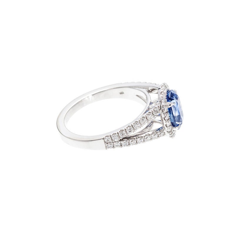 Oval sapphire and diamond split shank Halo engagement ring is from the Peter Suchy Workshop. 

1 oval natural bright cornflower blue Sapphire, approx. total weight 1.97cts, VS2, 8.59 x 5.51 x 4.81mm, just a hint of color zoning on the side for an