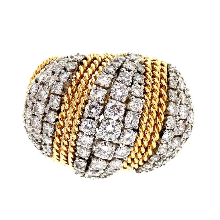 1950 handmade twisted wire 18k yellow gold dome ring. Faint remnants of a makers mark are not readable. Three Platinum prong sections hold bright white diamonds.

79 full cut diamonds, approx. total weight 3.16cts, G, VS

8 single cut diamonds,