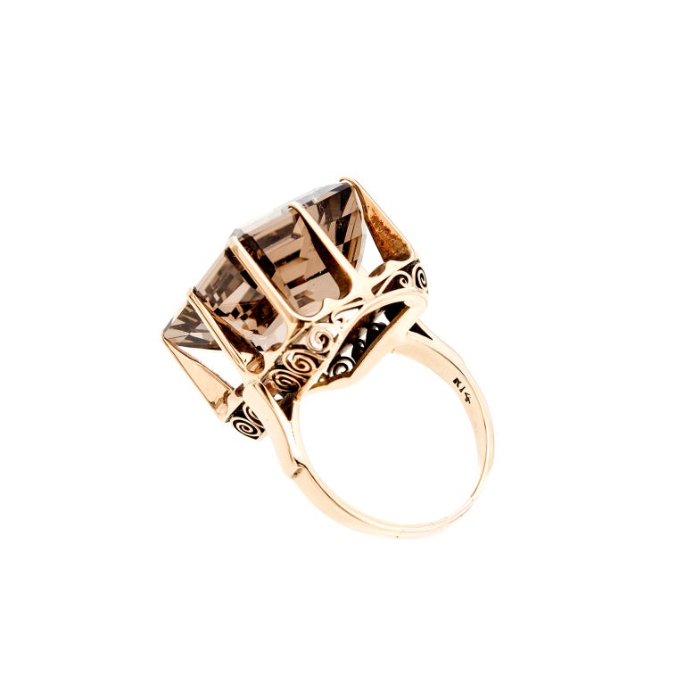 Late Art Deco 1945-1950 14k pink gold ring. On a pink gold scale of 1 to 10 with 10 as the deepest pink this scores a 7. Large clear smoky Quartz that is bright and well polished. Excellent condition. Looks great on the hand.

1 emerald cut smoky