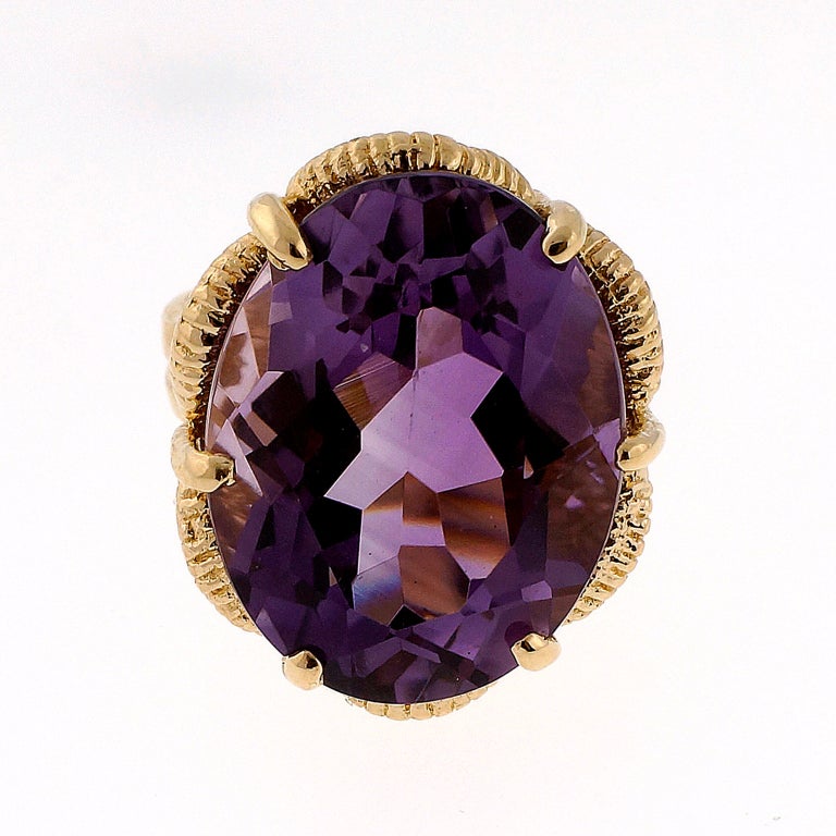 Hand made dramatic and bright 16.00ct Amethyst ring with hand textured side galleries. Excellent condition. Looks great on the hand. Well polished Amethyst.

One 21.7 x 14.8mm oval bright medium purple Amethyst, approx. total weight 16.00cts,