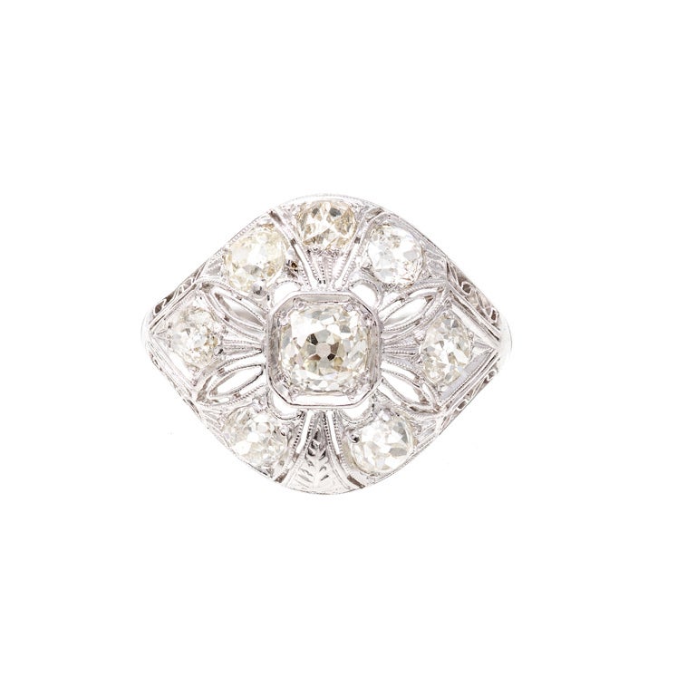 Art Deco 1927 pierced filigree dome ring c1927 with old mine brilliant cut diamonds. crt

1 old mine brilliant cut diamond, approximate total weight .49 carats, L-M, SI2, 

8 old mine brilliant cut diamonds, approximate total weight .75 carats,