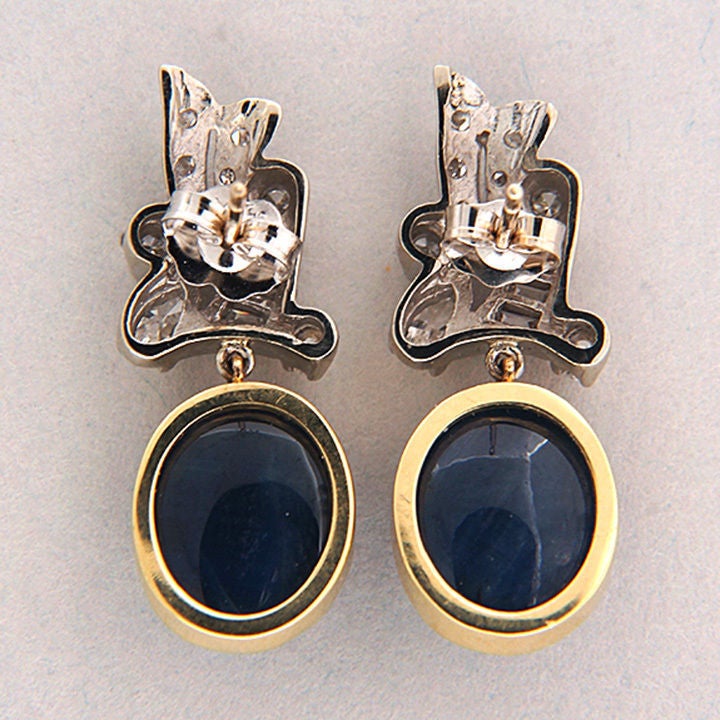 1950's dangle earrings with top gem fine blue Sapphire cabochons in yellow gold bezels and 14k white gold tops. Excellent condition. Looks great on the ear.
GIA certificate #2155085785.

 2 natural oval Sapphire cabochons NCL Type 1, simple heat