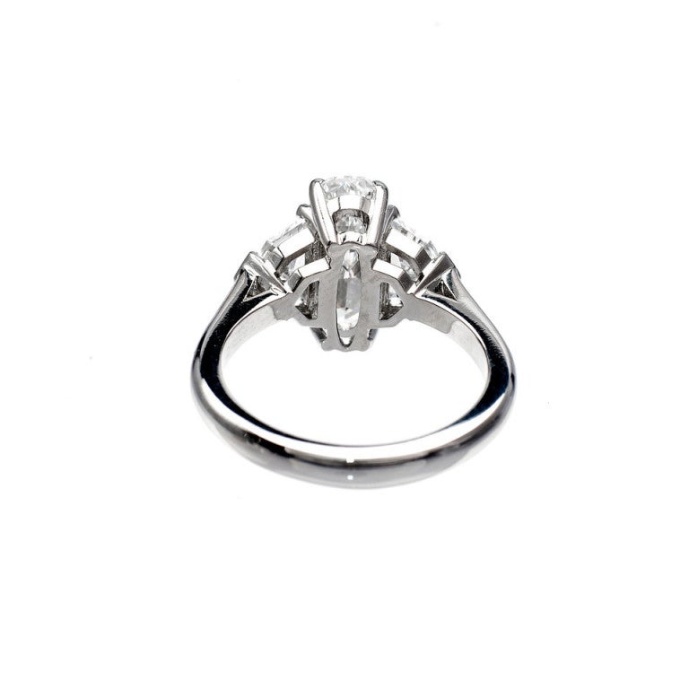 Hand made simple Platinum ring from the Peter Suchy Workshop. Super rare one of a kind elongated cushion cut center diamond over 11mm long with Ideal cutting and exceptional brilliance. Matched as it was originally by 2 Art Deco step cut side
