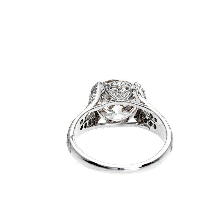 Ideal cut diamond engagement ring. in its original handmade, hand engraved platinum setting. Bead set split shank sides, with accent diamonds. Split prongs, hand engraved sides and shoulders. GIA certified.  

1 round ideal cut diamond, approx. 