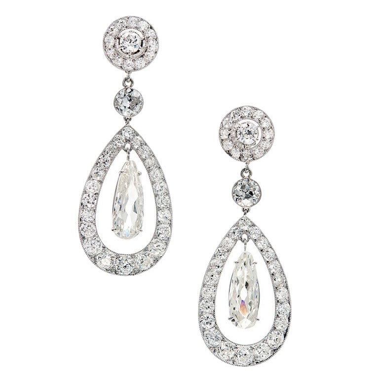 Early 1900's Cartier Paris dangle earrings with a clear stamp on the side of each. Old European cut and antique pear shaped, brilliant cut elongated custom cut dangles. GIA certified.  

1 modified pear brilliant diamond. 2.14ct total weight. M