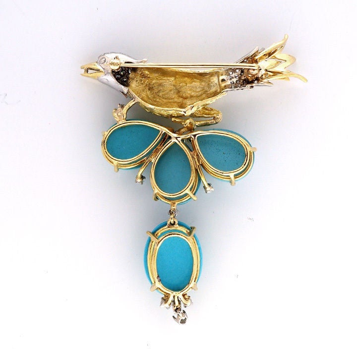 Natural gem quality genuine Robins egg blue Turquoise.  Handmade 3-d 14k greenish yellow and white gold bird pin, circa 1940.  Pave set with fine white full cut diamonds and a fine Ruby eye.  The bottom turquoise and diamond dangle.  Excellent