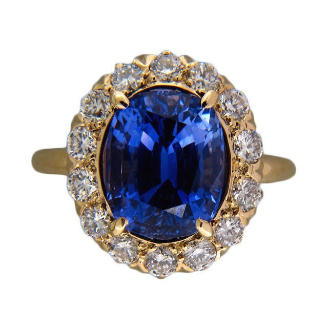 All original 1940's Tiffany + Co 14k yellow gold ring with fine near colorless near flawless full cut diamonds surrounding a very special one of a kind super bright medium slightly purplish blue all natural no heat 4.90ct cushion Sapphire with a