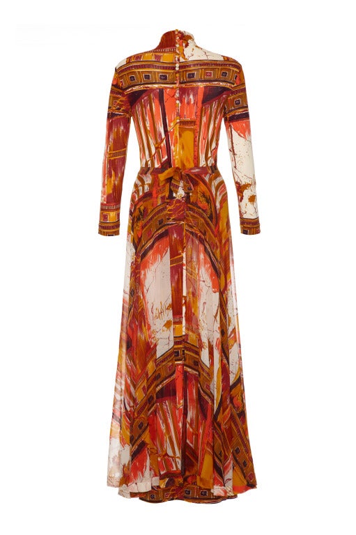 This is a striking ensemble made up of a long sleeved silk jersey tube dress with a matching silk chiffon skirt that ties around the waist and can also be worn tied around the neck as a cape.  Both pieces feature a fun Roman print of buildings in
