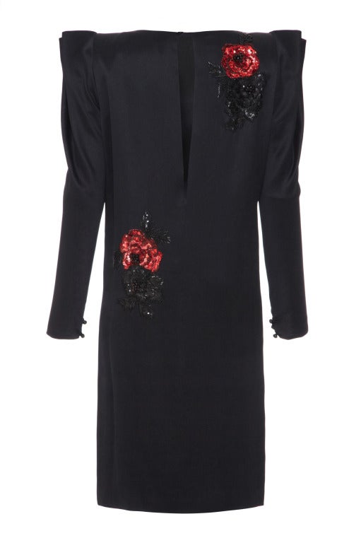 This dress from high end Italian couturier Andrea Odicini is classic 80’s with an amazing structured pleated shoulder detail and contrasting red sequins on black silk.  The straight cut knee length dress features full length sleeves and has an