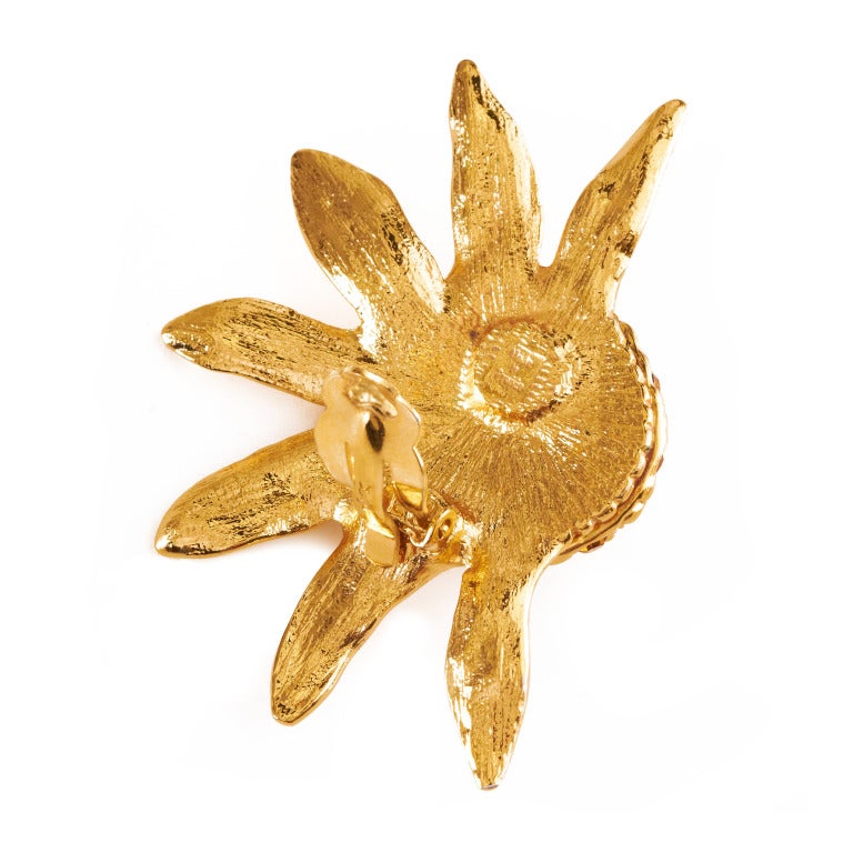 These Vintage Yves Saint Laurent clip on sunflower earrings are uber fabulous and an absolute must have.  Consisting of half a sunflower each with petals crafted in a shiny gold tone metal and a dome center with detailed amber rhinestone seedlings.