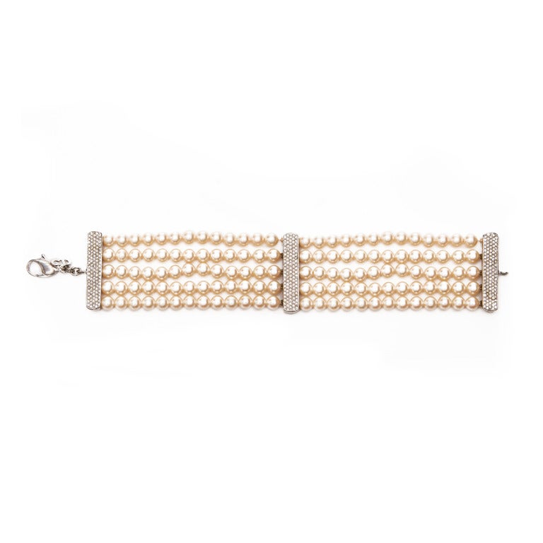 Stunning necklace and bracelet set made up of five rows of glass pearls separated in to sections by pretty diamante dividers.  Both pieces fasten with a clasp where there is also a small CD logo tag, and both are in good but restored condition.  The