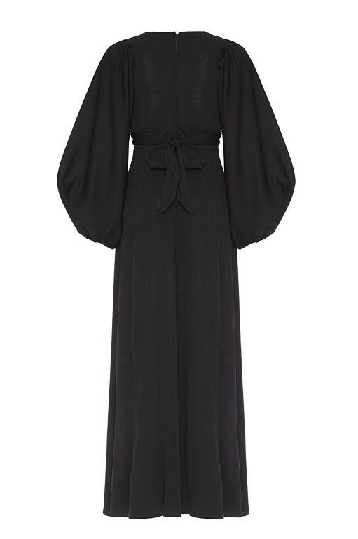 This fabulous iconic Ossie Clarke dress was designed for Radley and dates from around 1973.  It is typical of his style with full length billowing sleeves, a deep V neckline and a ruched section on the empire line with a tie to the back.  There is a