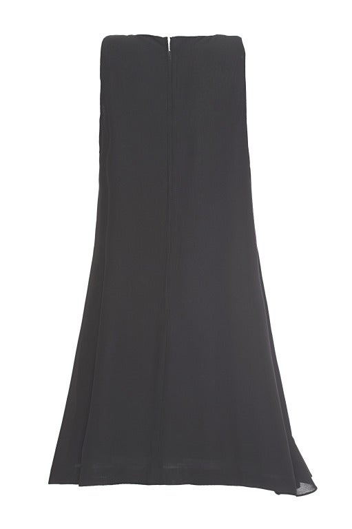 Exude '60s sophistication with this elegant knee length A-line dress - perfect for a cocktail party.  It features a decorative little bow detail on the shoulder, an asymmetric ruffle across the front and a round neckline. Centre back metal zipper