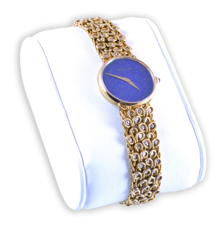 The watch has a 17-jewel Chopard movement and a Tiffany & Co. lapis dial, set in a 23.5 mm. case, number 21530/ 40091. The watch has a slightly tapering twisted wire woven link bracelet with a hinged tension clasp and fine chain safety. Adjustable