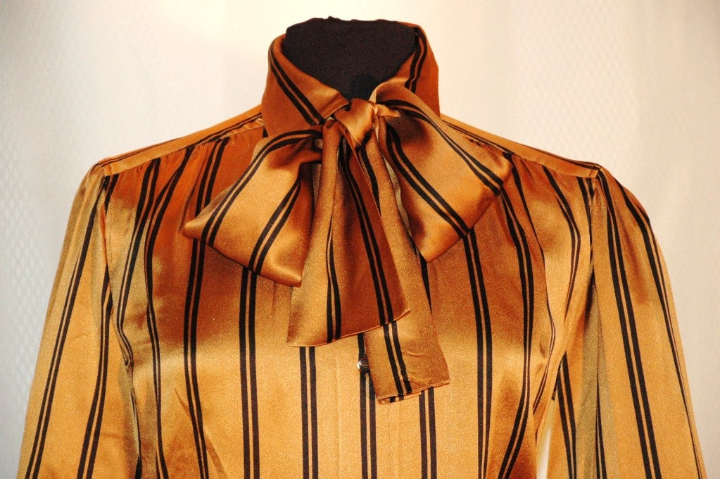This is a gorgeous vintage Yves Saint Laurent Rive Gauche carmel & black stripes 100% silk blouse with scarf. Made in France.  Size 38
Measurements:
Bust 40