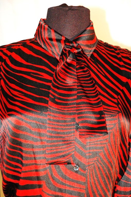 This is a gorgeous vintage Yves Saint Laurent Rive Gauche 100% silk blouse  red and black zebra print with bow scarf. Made in France.  Size 40
Measurements:
Bust 40