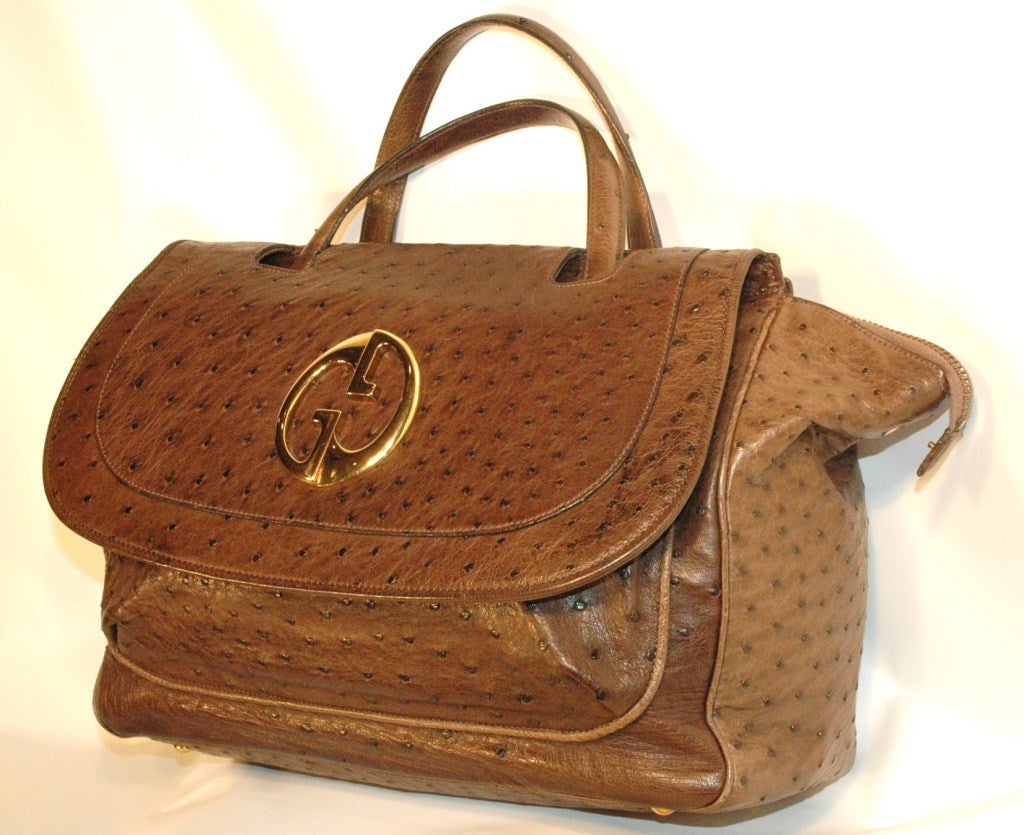 This is a Gucci 1973 brown ostrich top handle bag.  Antique gold hardware with leather lining made in Italy.  Double handles with a 6