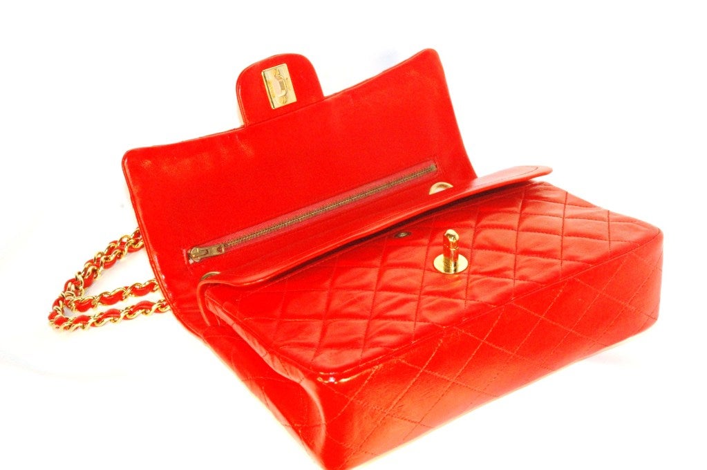 This is a vintage Chanel 2.55 red handbag with gold hardware recently service by Chanel and is in perfect clean incredible condition, especially given it's age.  This bag was rarely used and was well kept and stored for decades.  The zipper in an