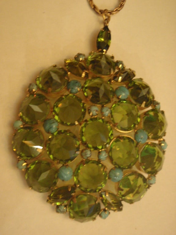 This is a vintage Schreiner New York signed gold tone green rhinestones reversed inverted position of rhinestones with turquoise accents.  Measures 3
