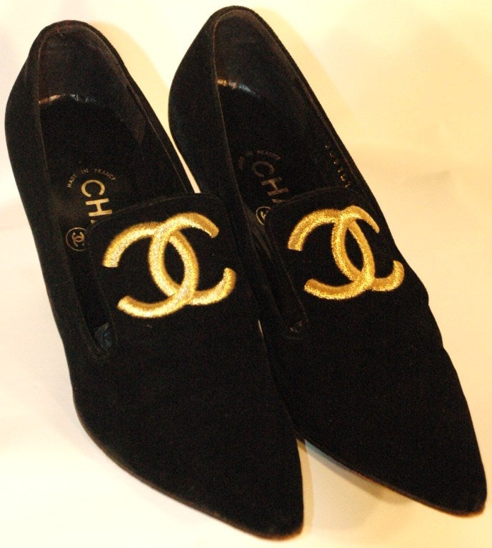 These are a pair of vintage 1993 Chanel black velour with gold embroidered CC logo size 36 1/2  Made in France.  Heel measures 3