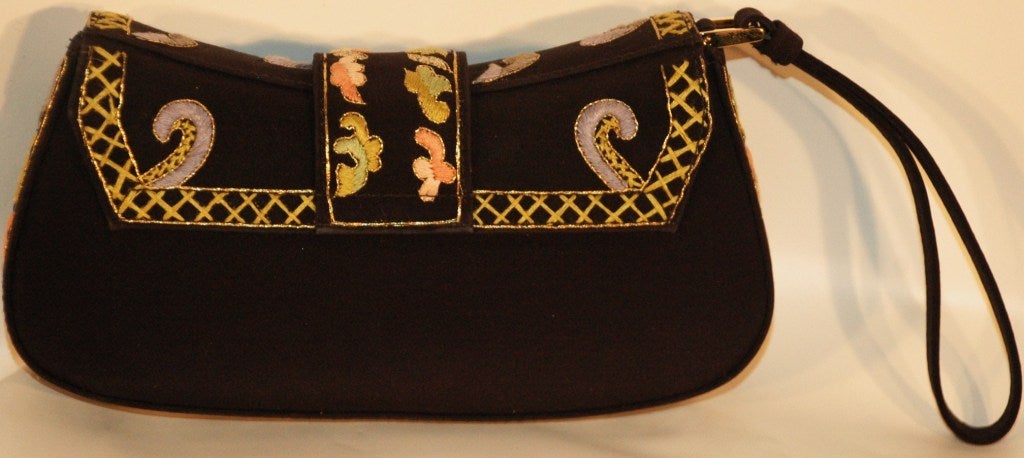 This is a Christian Dior Limited Edition multi color embroidered  wristlet with gold hardware. Numbered 0429 with authenticity card and dust cover.
Color: black w/light green, pink, lavender, gold, silver embroidery
Closure: magnetic snap button