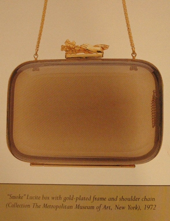 This is a vintage Judith Leiber clear translucent lucite acrylic evening handbag with gold metal frame and chain. Identical design in collection of Costume Institute at the Metropolitan Museum of Art, NY. 
Material: Acrylic lucite
Color: