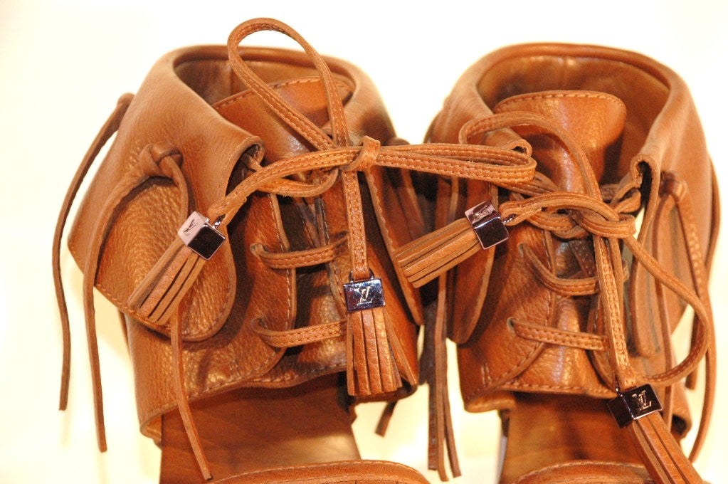 These are a new pair of collectible Louis Vuitton runway 2010 Rosa Sandal in Grained Calf Leather with fringe and purple metal heel with Louis Vuitton engraved.  Made in Italy
Size 38 1/2 
Height: 4″
This clog-sandal in grained calf leather