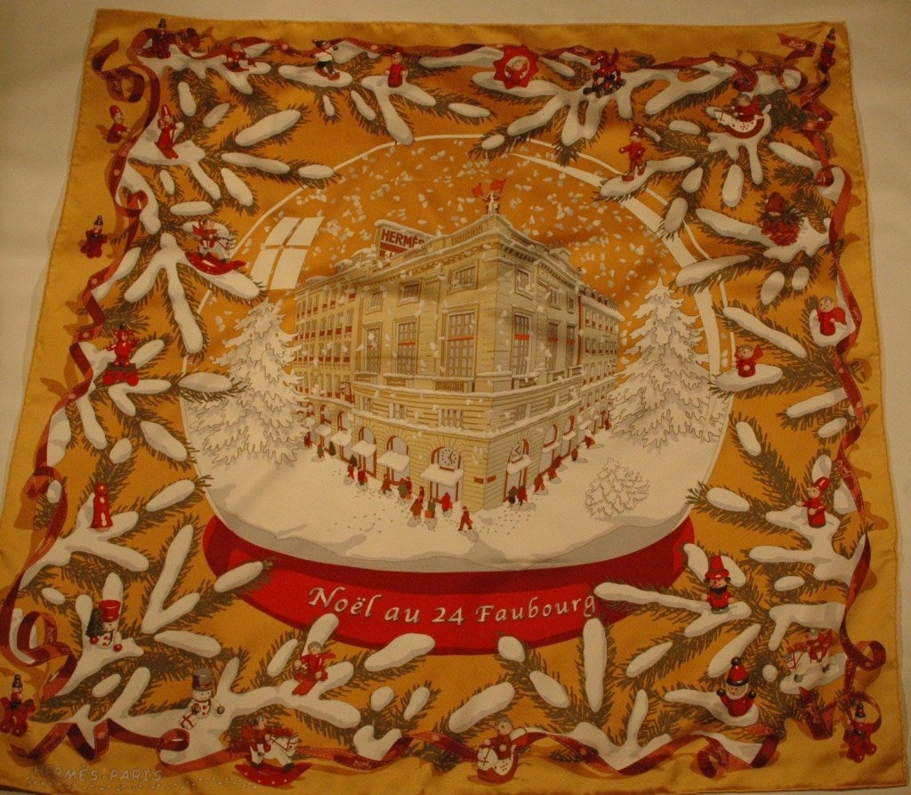 HERMES noel au 24 faubourg  (“Christmas at 24 Faubourg”) Silk Scarf that is brand new in box. Designed by artist, Dimitri Rybaltchenko for Hermes, the motif showcases Hermes’ historical flagship boutique, located at 24 rue du Faubourg Saint-Honore
