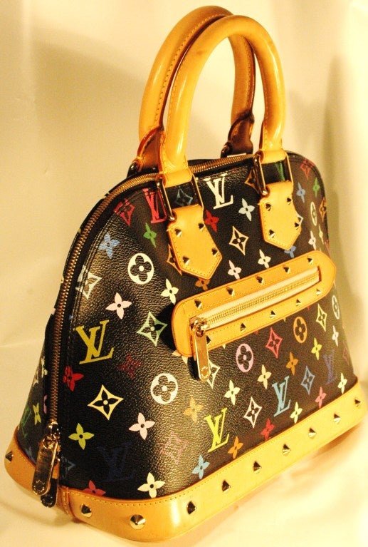This is a iconis Louis Vuitton Alma Murakami multi color black  handbag with double handles and zippers. Has interior phone and pouch pockets. In great condition with minor marks on the bottom.
Made in France