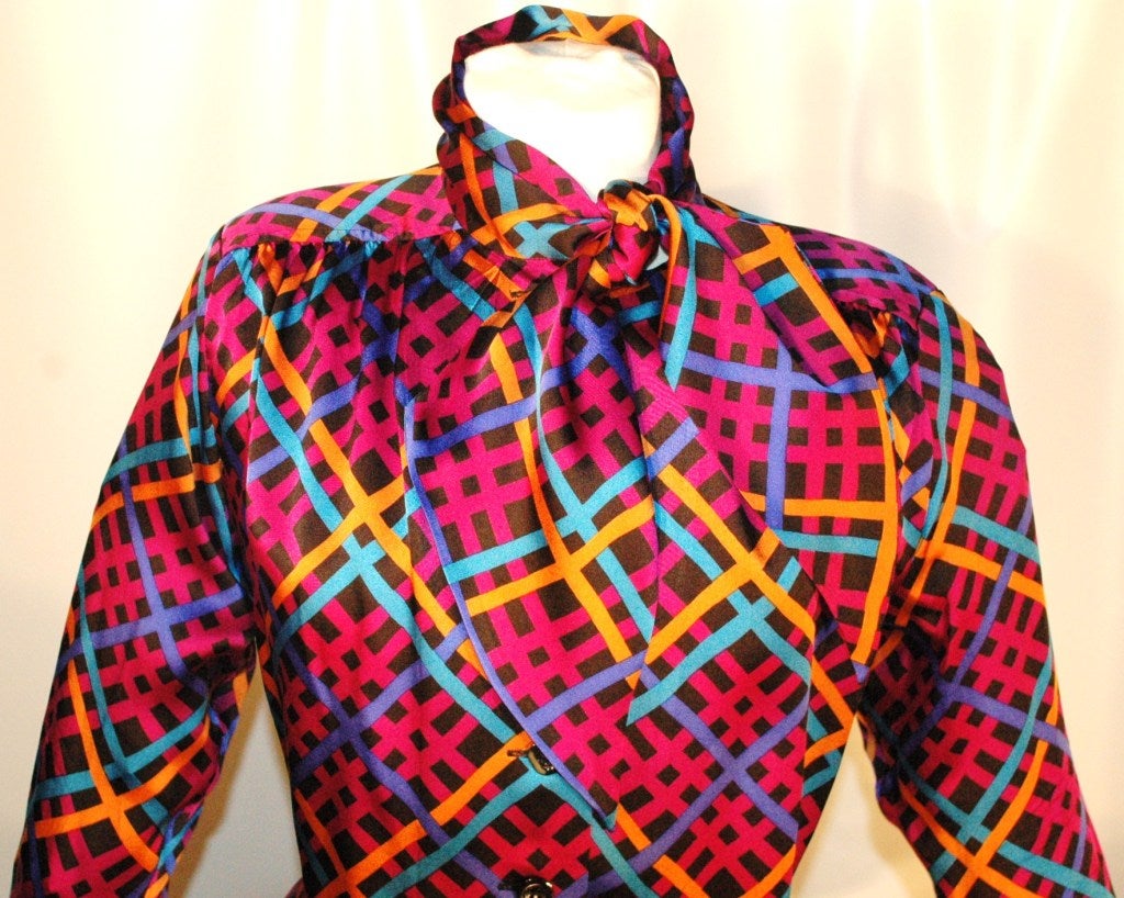 This is a vintage 1985 Yves Saint Laurent Rive Gauche 100% silk bow blouse long sleeves, thin shoulder pads with vibrant colors.  Same print featured on Rachael Zoe episode 3.
Size 38
Made In France
Measurements:
length 26