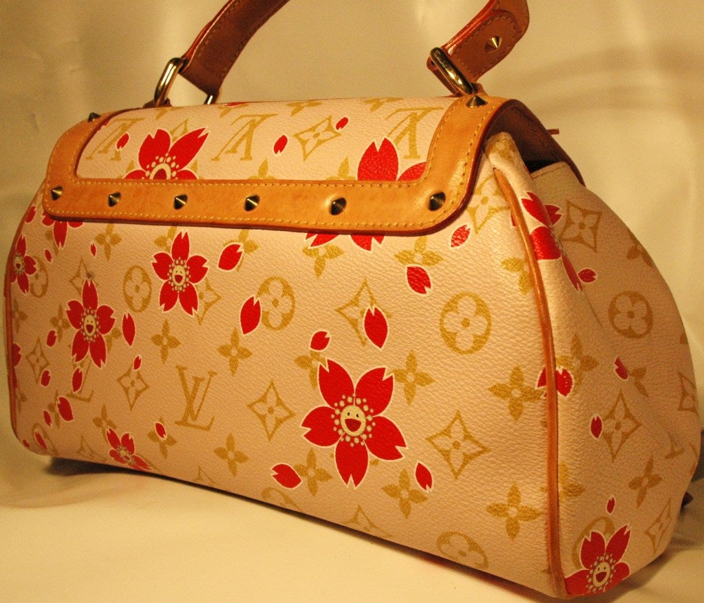 Louis Vuitton Murakami cherry blossom Sac Retro bag was released in spring/summer 2003 by collaboration between Louis Vuitton and Takashi Murakami. This color combination (red blossom in pink) is very rare to find! It is made of pink monogram canvas