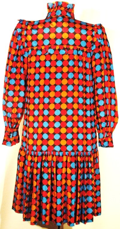 This is a Yves Saint Laurent Rive Gauche silk Polka Dot multi color dress with ruffle collar and built in scarf bow size 40.  Two side pockets.  Drop waist.