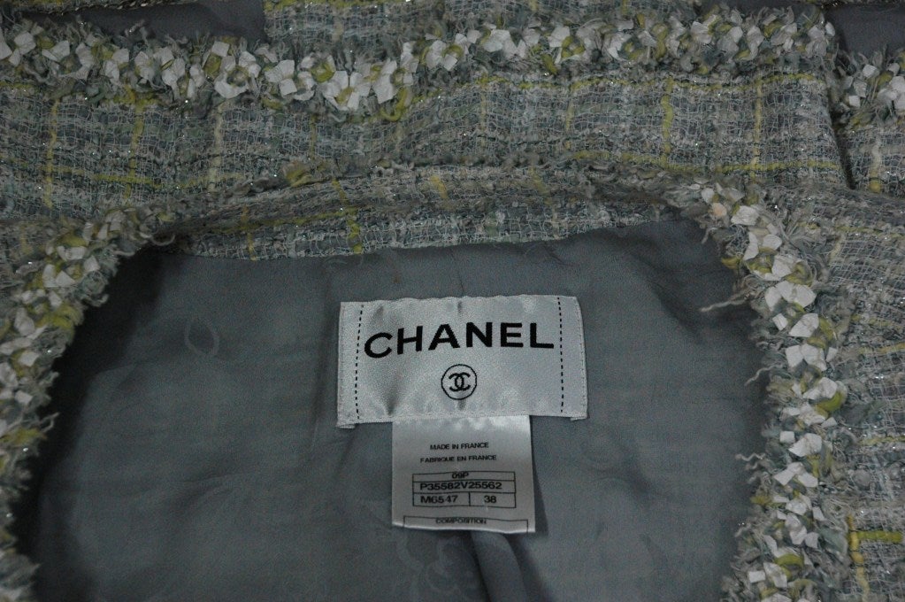 This is a 2009 Chanel 09P tweed jacket with silver buttons
colors white, silver, grey, lime green
Size 38
50% cotton
19% wool
18% rayon
6% nylon
1% polyester
lining 100% silk.
Measurements:
shoulders 17
