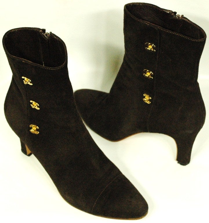 These are a pair of vintage Chanel brown suede ankle boots with triple gold CC metal logo details.  Inner zipper.  Size 39 1/2
3