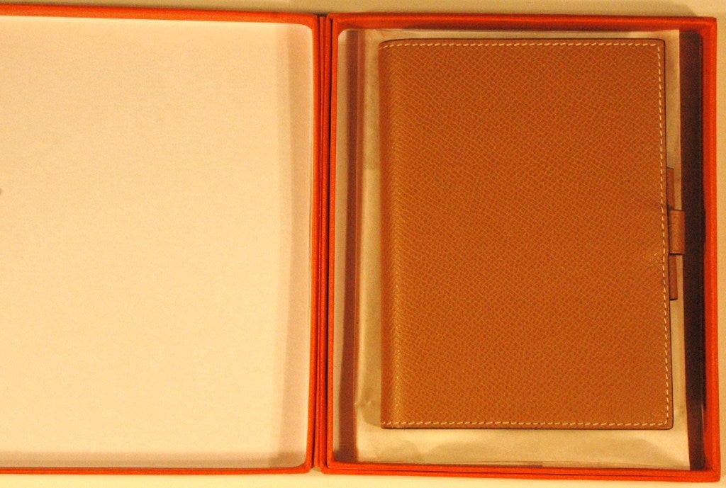 This is an Hermes Agenda Date Planner, address book, maps, note book in new condition.  Never used.  Made in France Still in box. 2013 model insert refill.
approximate measurements 5 x 4