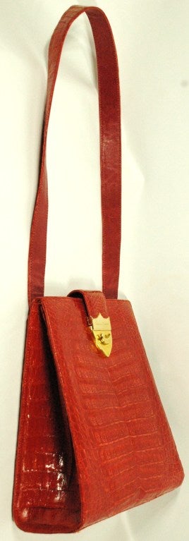 This is a vintage rare Paloma Picasso red crocodile shoulder strap handbag in perfect condition.  Made in Italy  Elegant and functional.  Gold toned hardware with signature.  Leather lined super soft.  Marked Genuine Crocodile.
Back slot