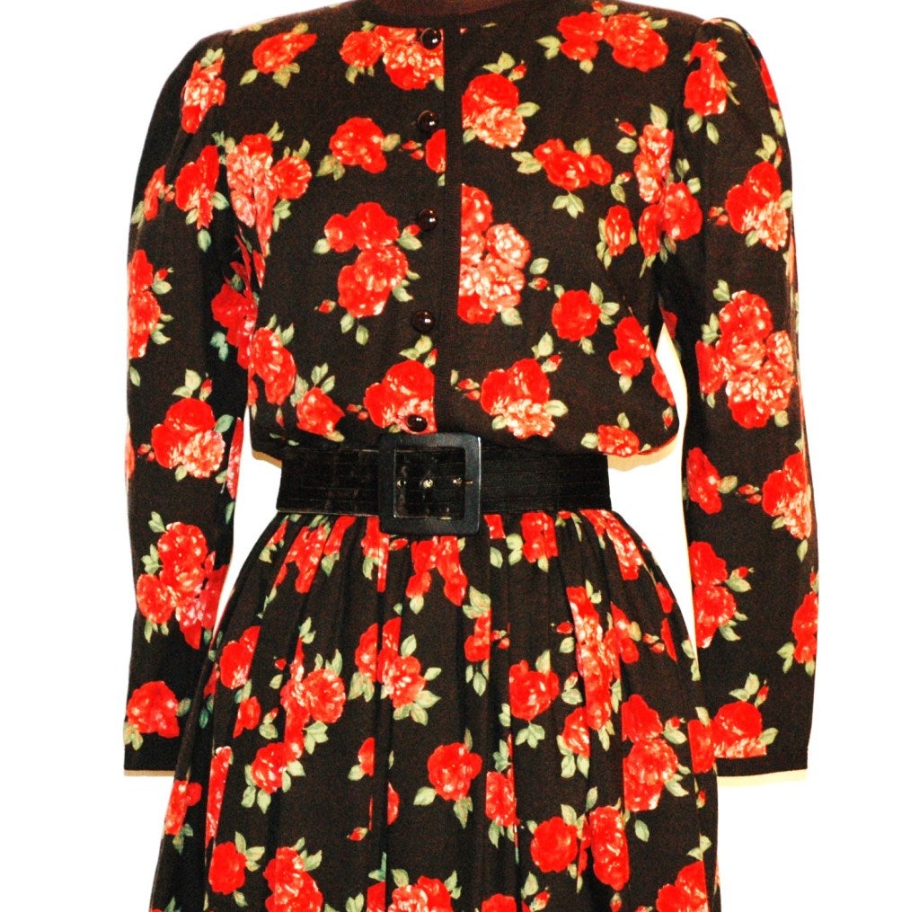 This is a vintage Yves Saint Laurent Rive Gauche wool dress with floral red print and velvet trim with matching belt.  Size 38.
Measures:
Bust up to 36