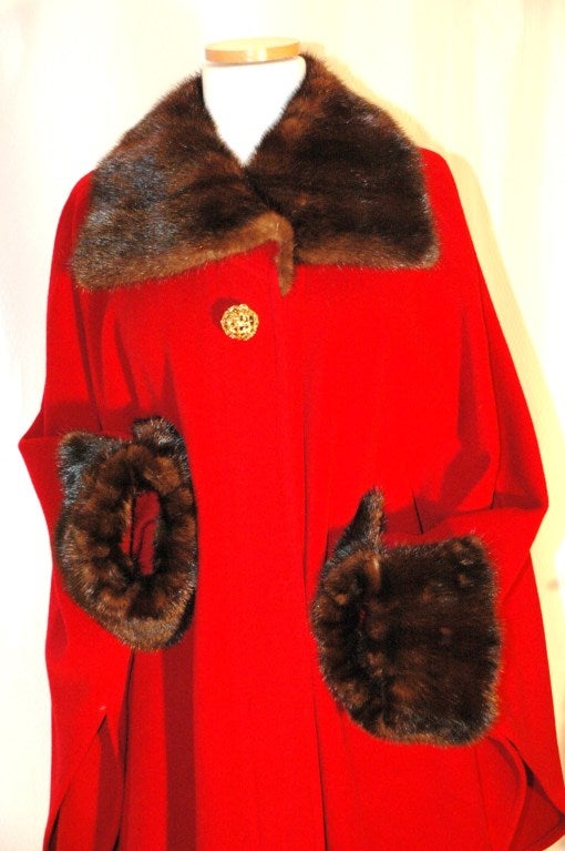 This is an amazing Yves Saint Laurent red wool cape with Mink collar and cuffs.