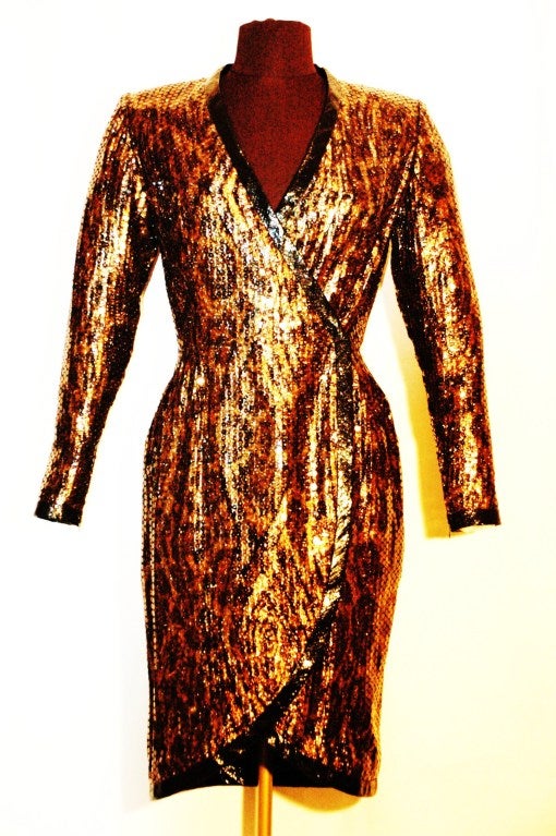 This is a vintage 1980s Balmain Ivoire sexy longsleeve animal print with sequence over-lay short cocktail dress wrap around snap and hook closure. zippers at the wrist.