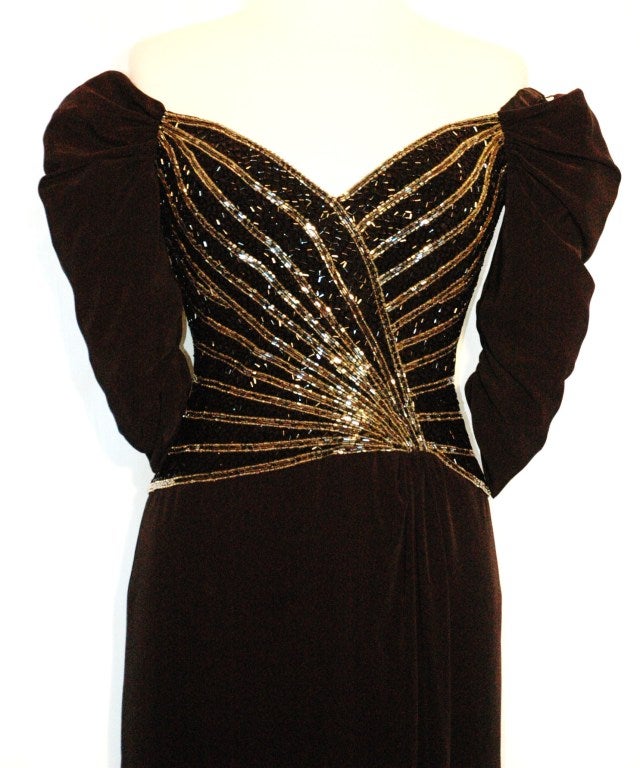 This is a Bob Mackie Boutique black long evening gown with torso beading and 3/4 long sleeves off shoulders size 4.  Perfect condition 75% triacetate 25% polyester fully lined.
Measurements:
Bust 34