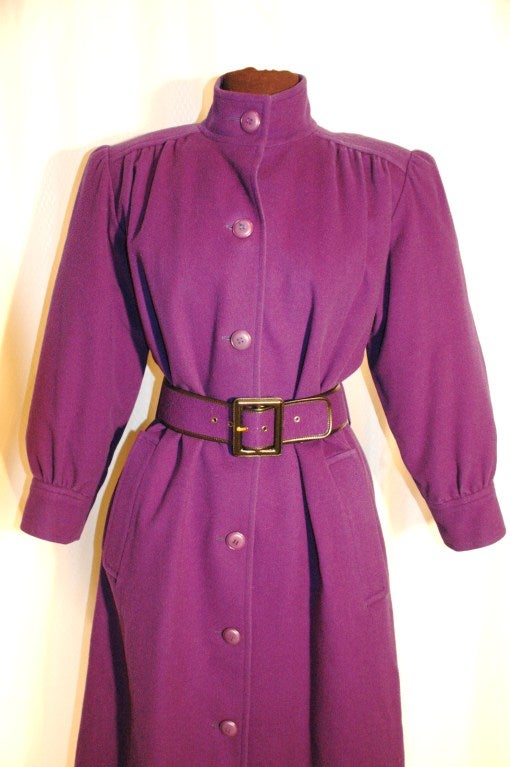 This is a vintage Yves Saint Laurent Rive Gauche purple wool button up coat with matching belt. Size 36.  
Measures 46